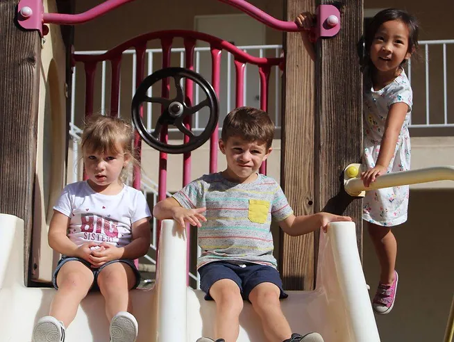 Care Bears Class with three kids playing on slide